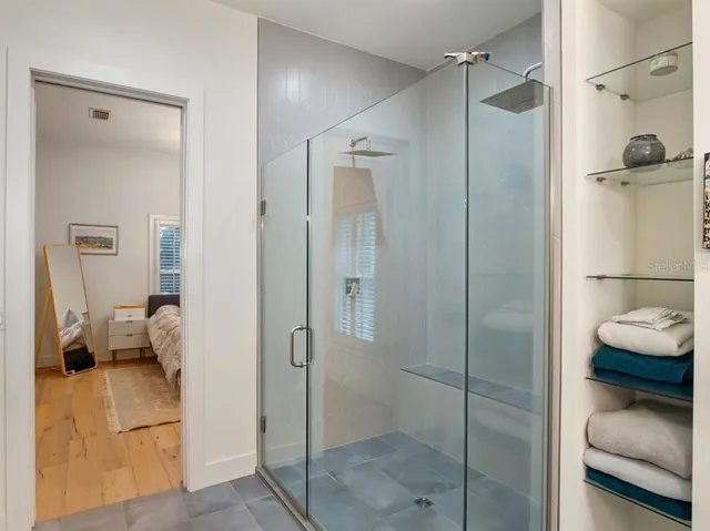 a bathroom with a shower and a sink