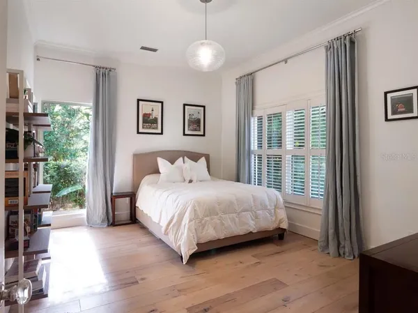 a bedroom with a large bed and a window