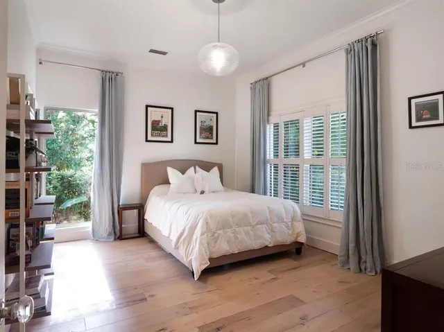 a bedroom with a large bed and a window