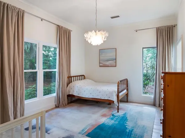 a living room with a bed furniture and a large window