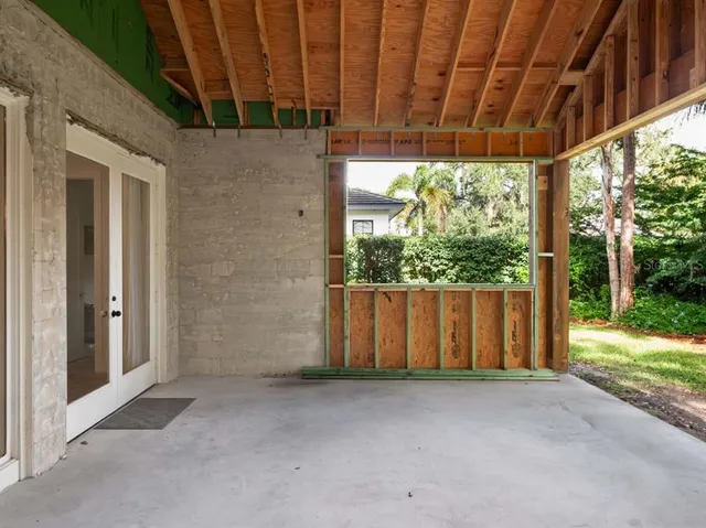 a view of a room with a large window and tree
