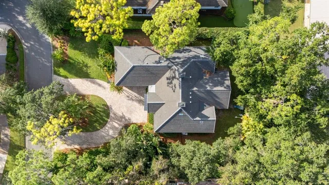 an aerial view of a house with a yard