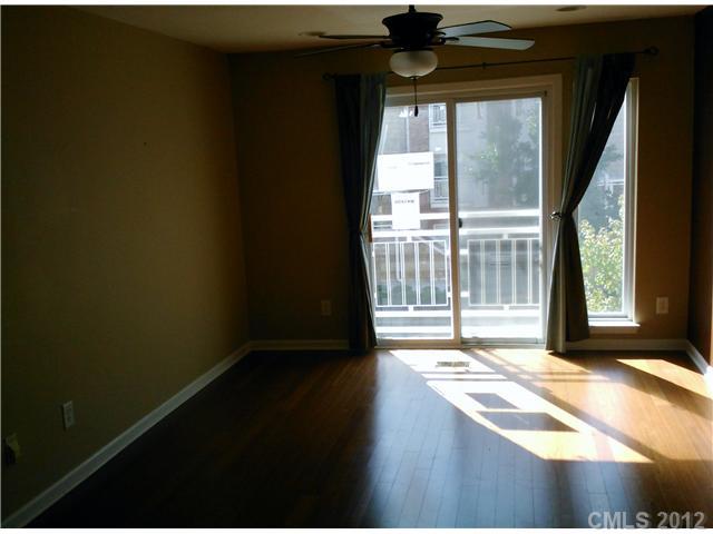 631 Raphael Place Charlotte, NC 28205 - Photo 2 of 5 a view of empty room with wooden floor and fan