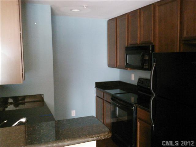 631 Raphael Place Charlotte, NC 28205 - Photo 4 of 5 a kitchen with a sink and cabinets