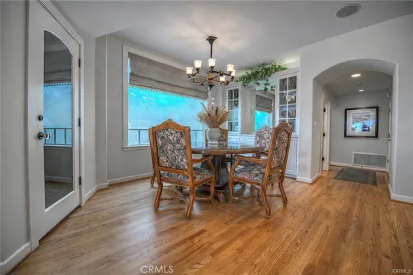 a view of a dining room with furniture and wooden floor