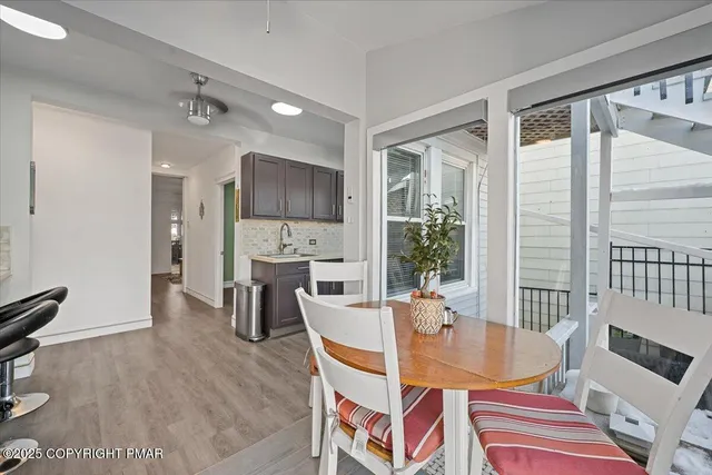 a view of a livingroom with wooden floor and a piano