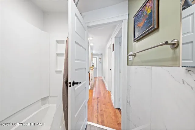 a kitchen with kitchen island wooden cabinets a sink and a large window