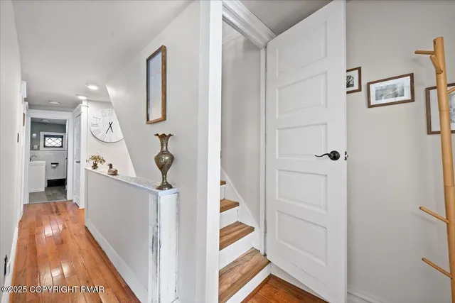 a view of entryway and hall with wooden floor