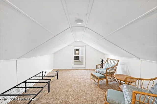 a view of a kitchen with refrigerator and cabinets