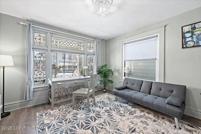 a living room with furniture or couch and a wooden floor