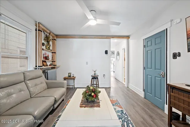 a living room with furniture and wooden floor