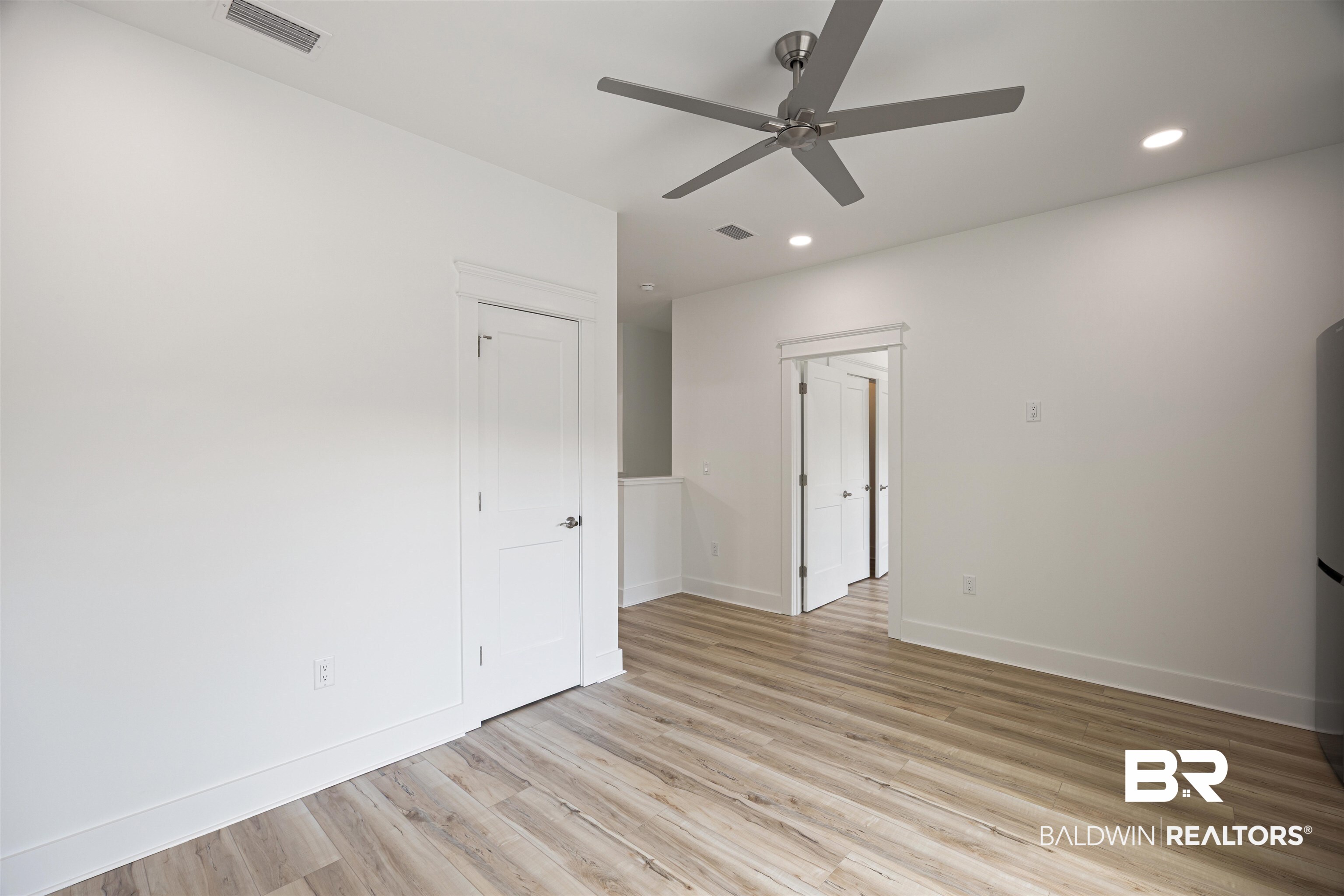 27591 Canal Road Orange Beach, AL 36561 - Photo 45 of 51 Unfurnished bedroom featuring light wood finished floors, recessed lighting, a ceiling fan, and freestanding refrigerator