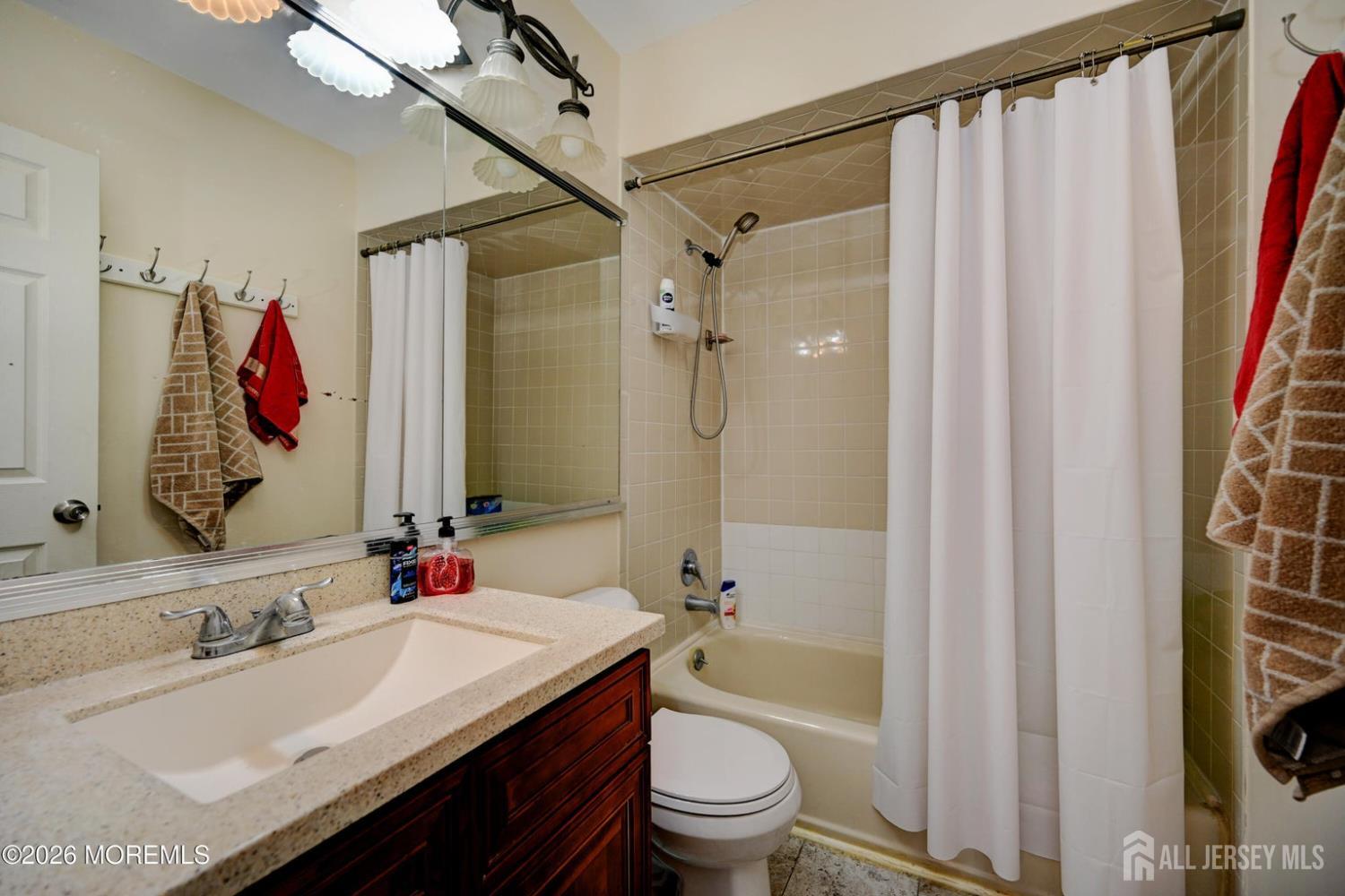 22 Borell Square Parlin, NJ 08859 - Photo 21 of 32 a bathroom with a granite countertop sink a toilet and shower