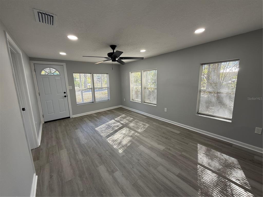 1205 Dell Street Starke, FL 32091 - Photo 7 of 12 a view of empty room with wooden floor and fan