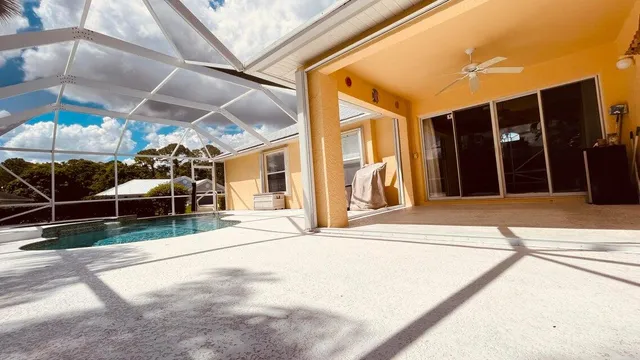 a view of a kitchen with a refrigerator and a stove top oven