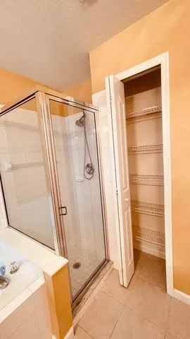 an empty room with a ceiling fan and carpet