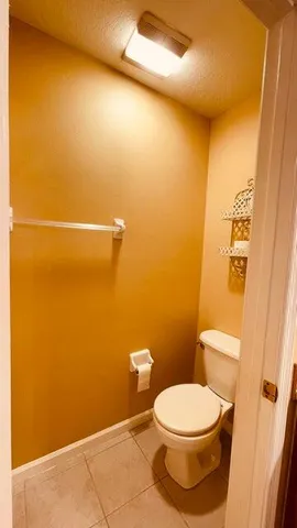 an empty room with a ceiling fan and carpet