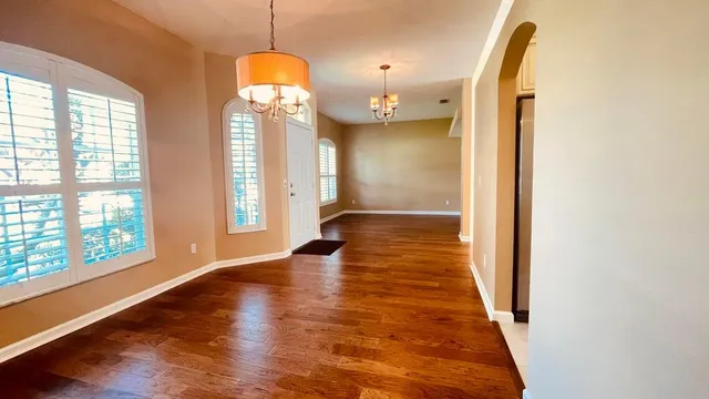 a kitchen with white cabinets and appliances