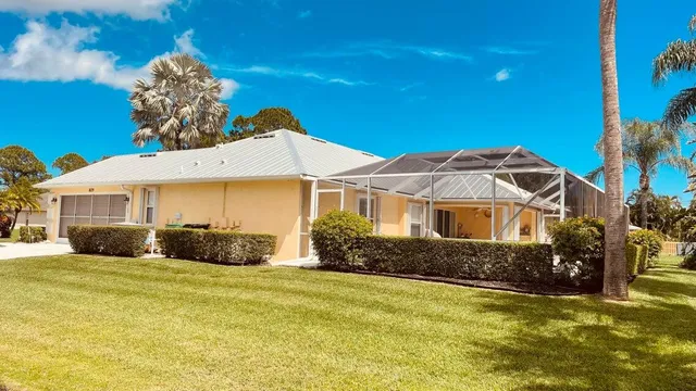 a bathroom with a granite countertop sink a mirror and shower