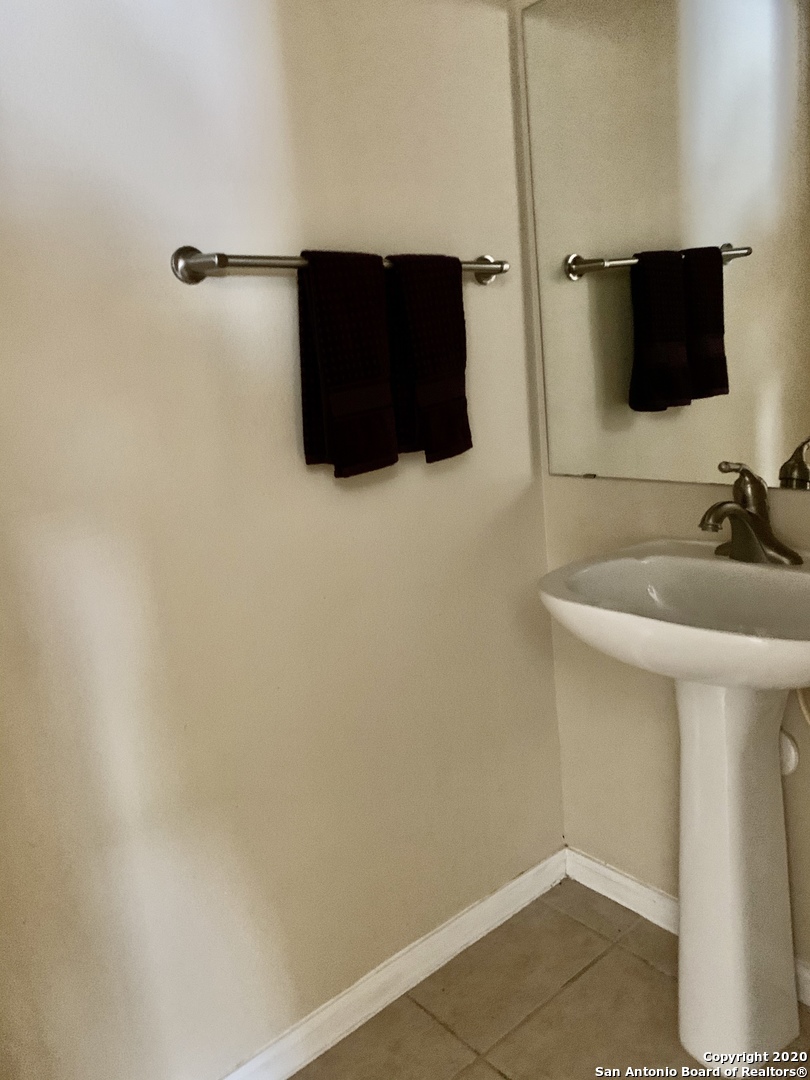 6160 Eckhert Road, Unit 505 San Antonio, TX 78240 - Photo 15 of 36 a bathroom with a sink and a mirror