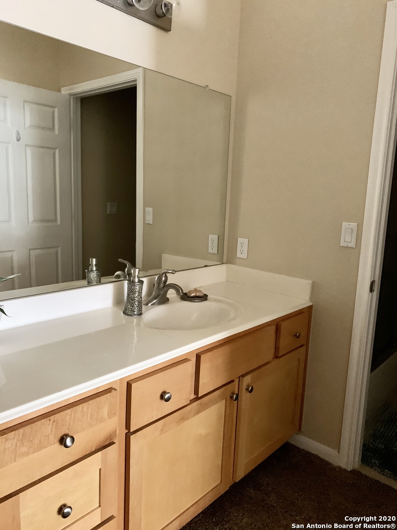 6160 Eckhert Road, Unit 505 San Antonio, TX 78240 - Photo 16 of 36 a bathroom with a sink and a mirror