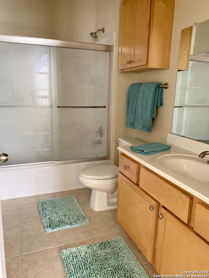6160 Eckhert Road, Unit 505 San Antonio, TX 78240 - Photo 21 of 36 a bathroom with a sink a toilet and shower