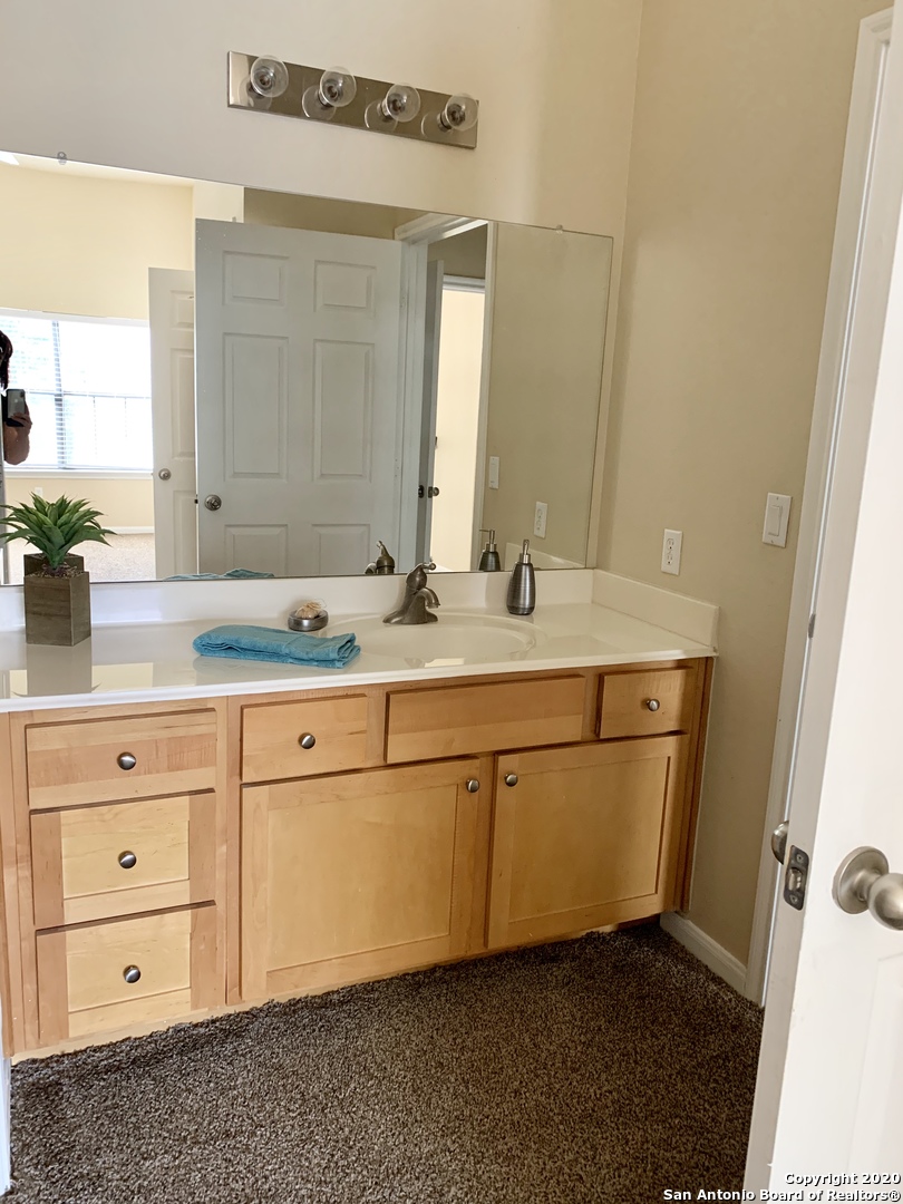 6160 Eckhert Road, Unit 505 San Antonio, TX 78240 - Photo 22 of 36 a bathroom with a sink and a mirror