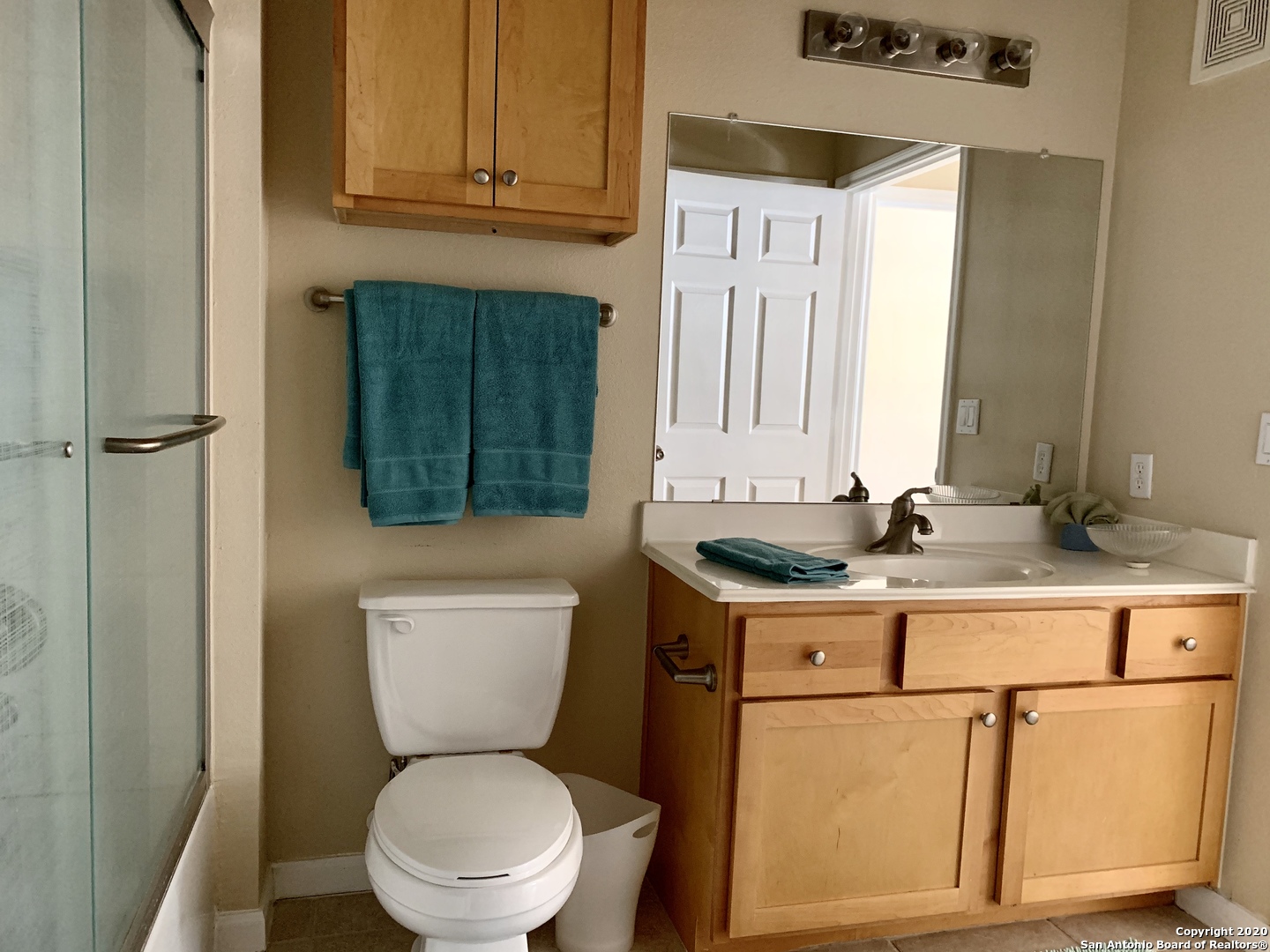 6160 Eckhert Road, Unit 505 San Antonio, TX 78240 - Photo 24 of 36 a bathroom with a toilet a sink and a mirror