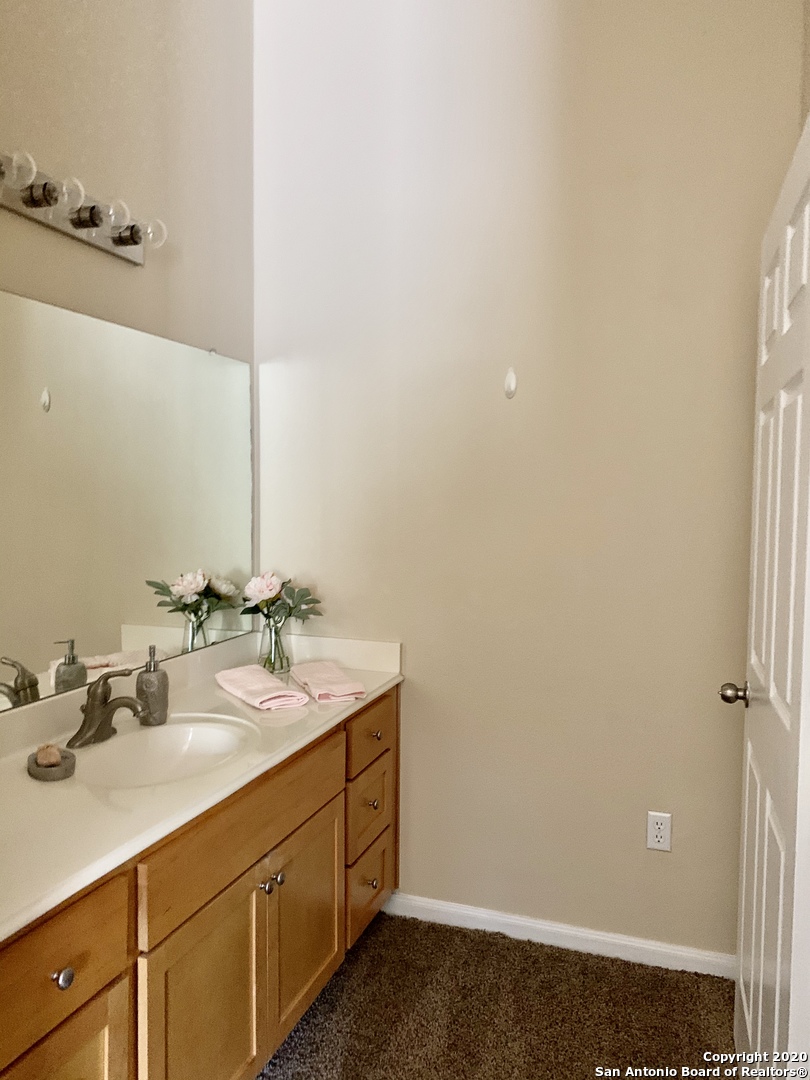6160 Eckhert Road, Unit 505 San Antonio, TX 78240 - Photo 26 of 36 a bathroom with a sink and a mirror