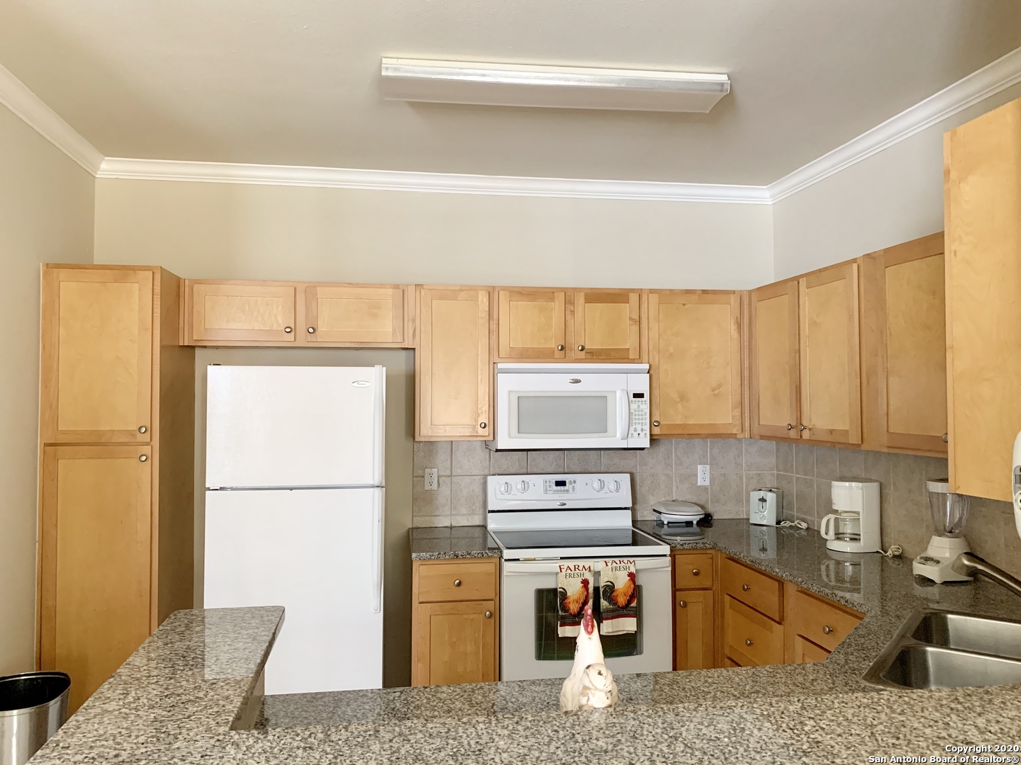 6160 Eckhert Road, Unit 505 San Antonio, TX 78240 - Photo 9 of 36 a kitchen with a refrigerator and a stove