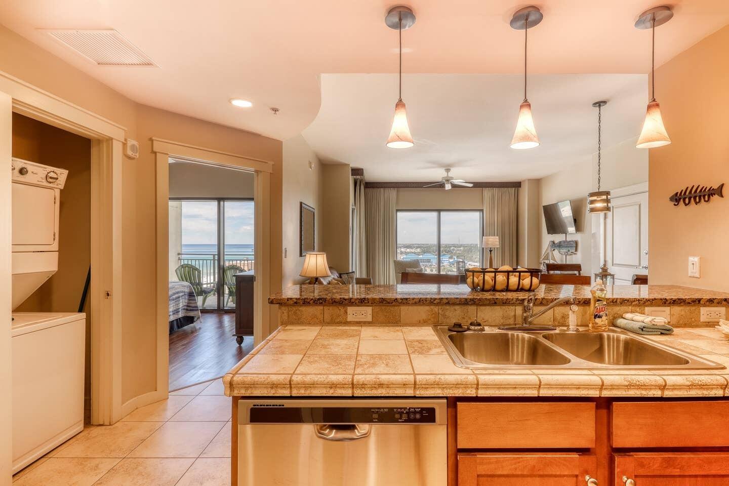 15100 Front Beach Road, Unit 1107 Panama City Beach, FL 32413 - Photo 13 of 24 a kitchen with a sink a counter and a view of living room
