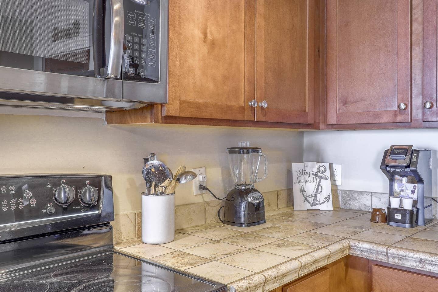 15100 Front Beach Road, Unit 1107 Panama City Beach, FL 32413 - Photo 14 of 24 a kitchen with a sink and cabinets