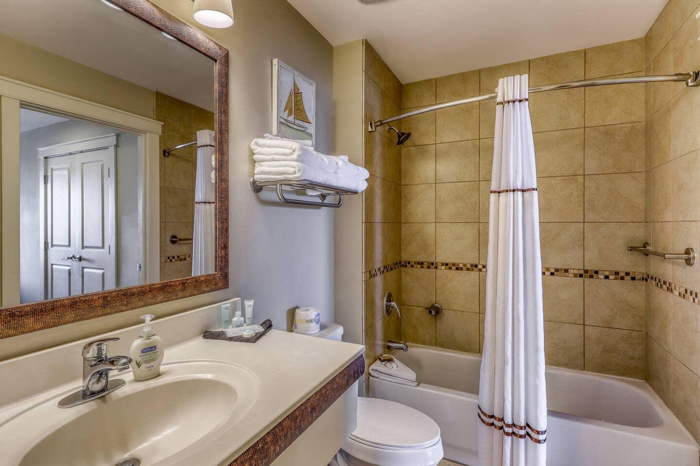 15100 Front Beach Road, Unit 1107 Panama City Beach, FL 32413 - Photo 15 of 24 a bathroom with a sink a toilet and shower