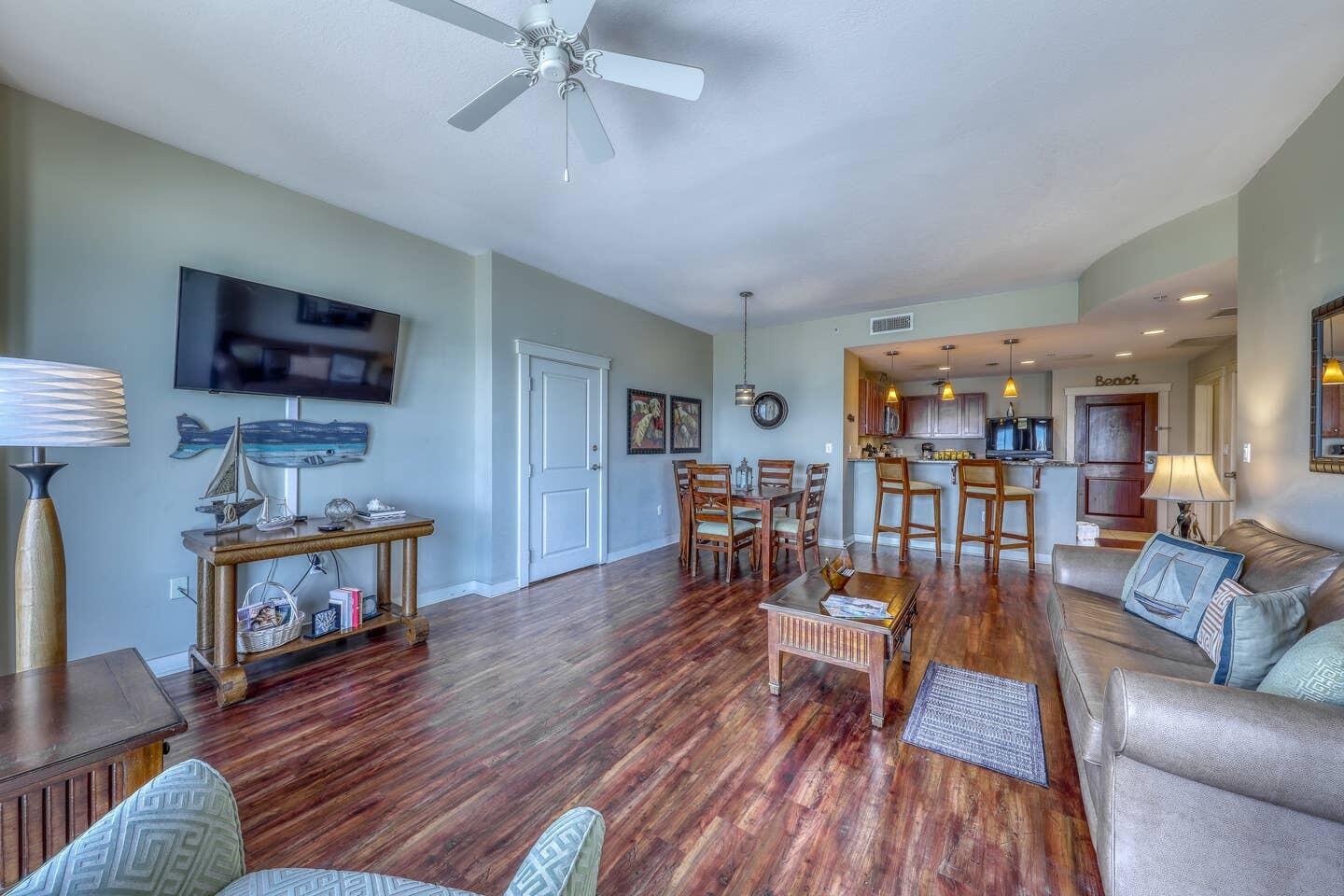 15100 Front Beach Road, Unit 1107 Panama City Beach, FL 32413 - Photo 6 of 24 a living room with furniture and a wooden floor
