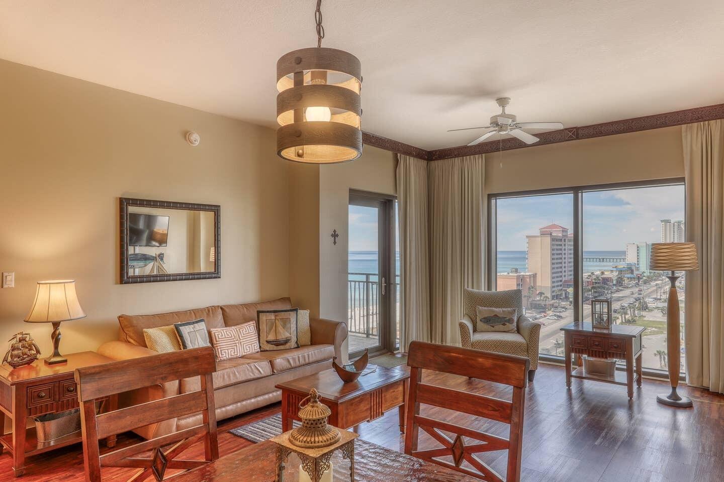 15100 Front Beach Road, Unit 1107 Panama City Beach, FL 32413 - Photo 8 of 24 a living room with furniture a chandelier and a dining table