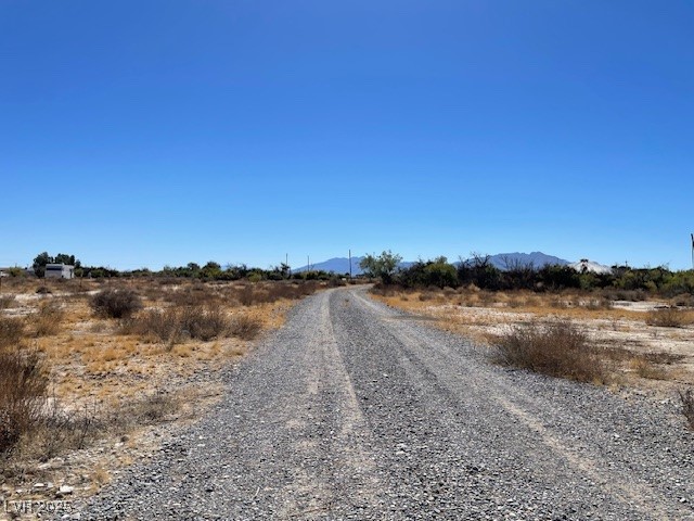 3681 Quail Run Road Pahrump, NV 89060 - Photo 3 of 11 View of dirt / gravel road with a mountain view and a view of countryside