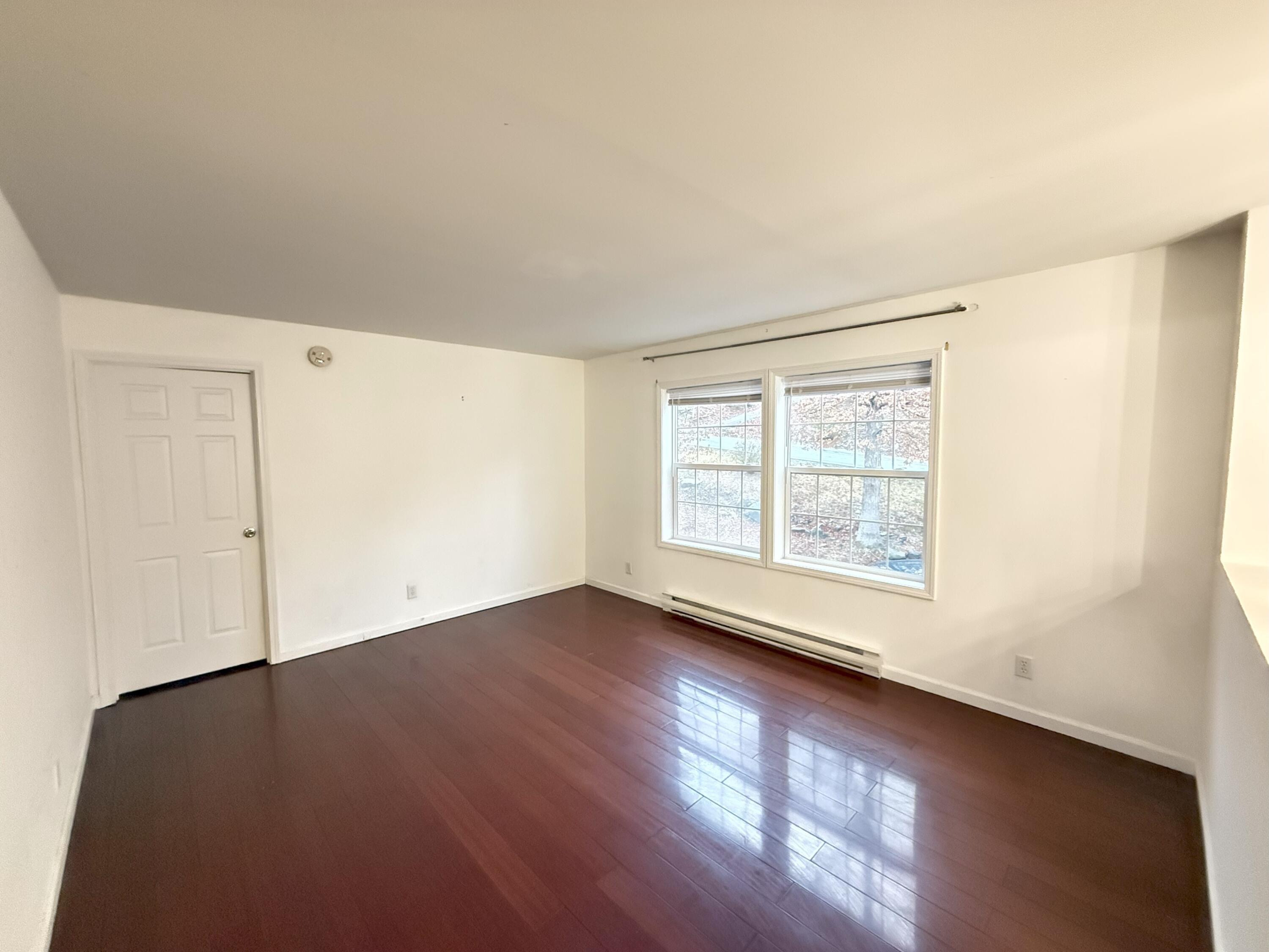 6486 Decker Road Bushkill, PA 18324 - Photo 15 of 53 an empty room with wooden floor and windows