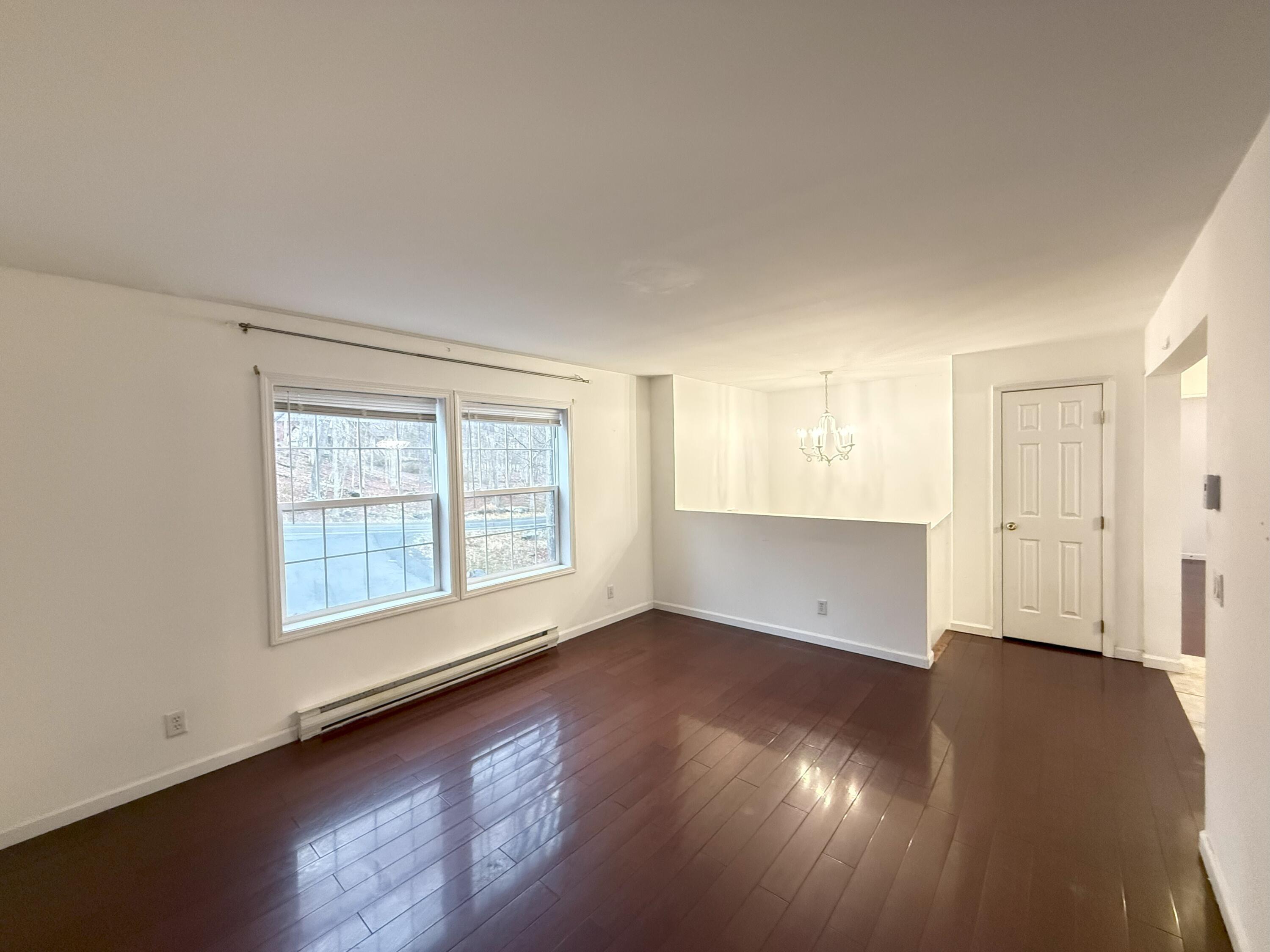6486 Decker Road Bushkill, PA 18324 - Photo 16 of 53 an empty room with wooden floor and windows