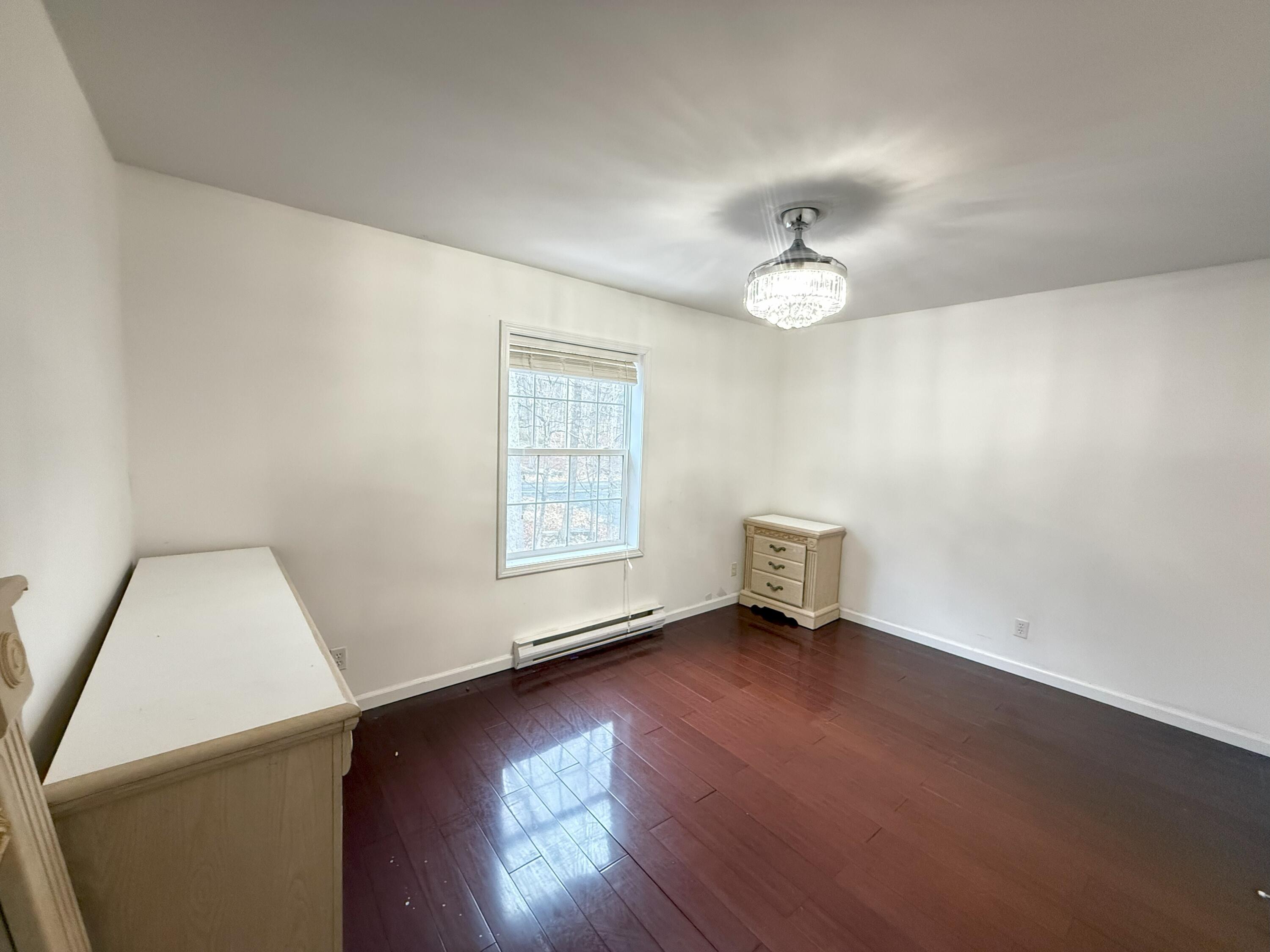 6486 Decker Road Bushkill, PA 18324 - Photo 17 of 53 an empty room with wooden floor and windows