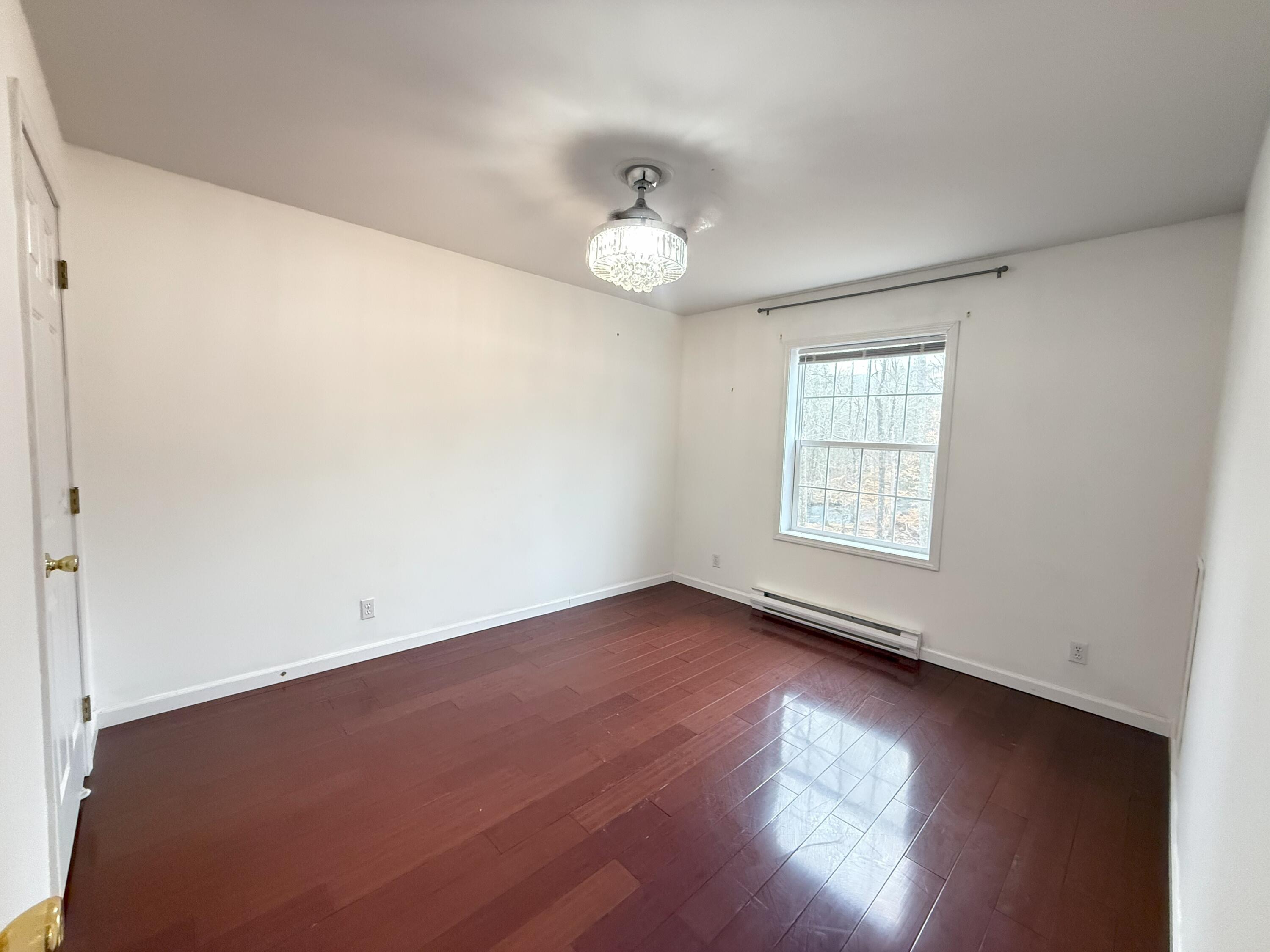 6486 Decker Road Bushkill, PA 18324 - Photo 18 of 53 an empty room with wooden floor and windows