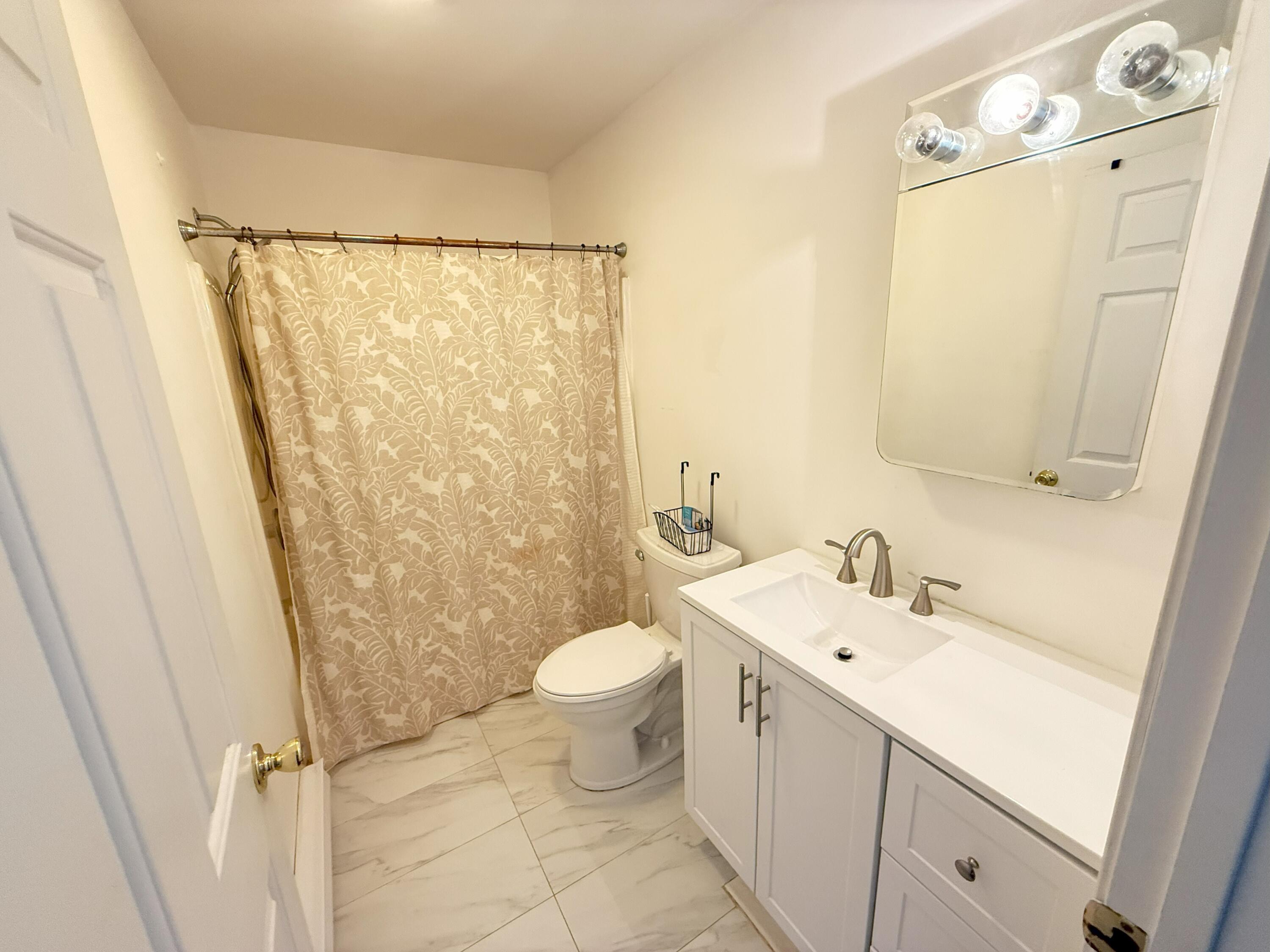 6486 Decker Road Bushkill, PA 18324 - Photo 19 of 53 a bathroom with a sink a toilet and shower curtain