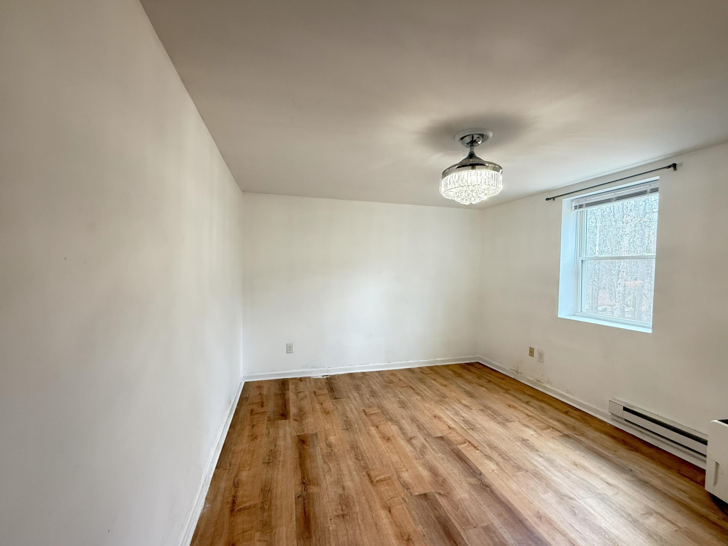 6486 Decker Road Bushkill, PA 18324 - Photo 22 of 53 wooden floor in an empty room with a window