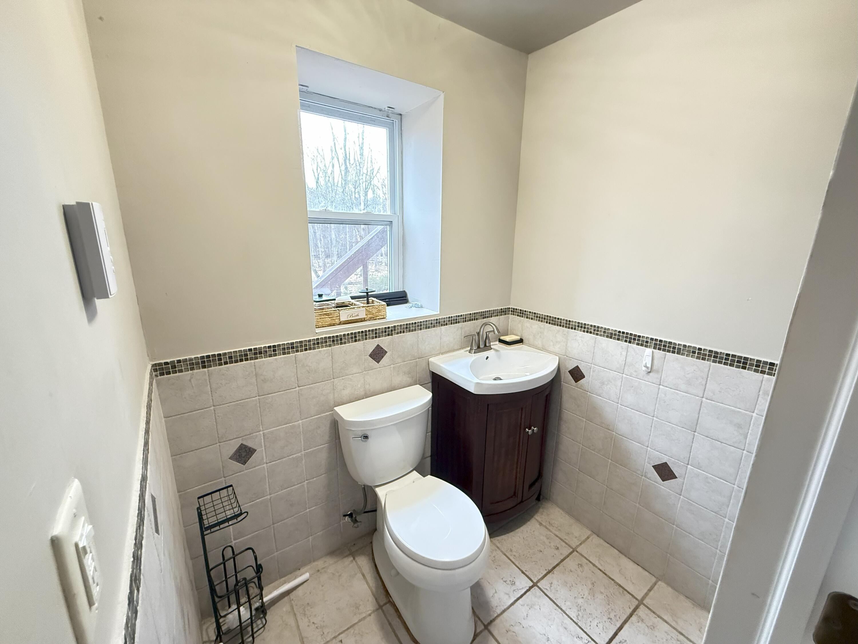 6486 Decker Road Bushkill, PA 18324 - Photo 25 of 53 a bathroom with a toilet sink and mirror