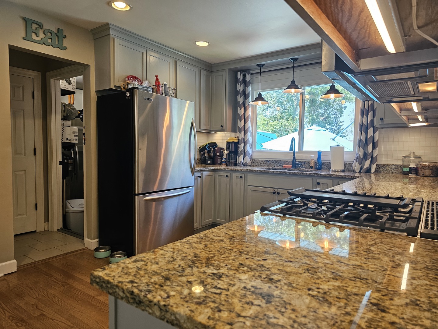 2314 Beck Road Lindenhurst, IL 60046 - Photo 4 of 11 a kitchen with stainless steel appliances granite countertop a refrigerator a sink a stove and a wooden floors