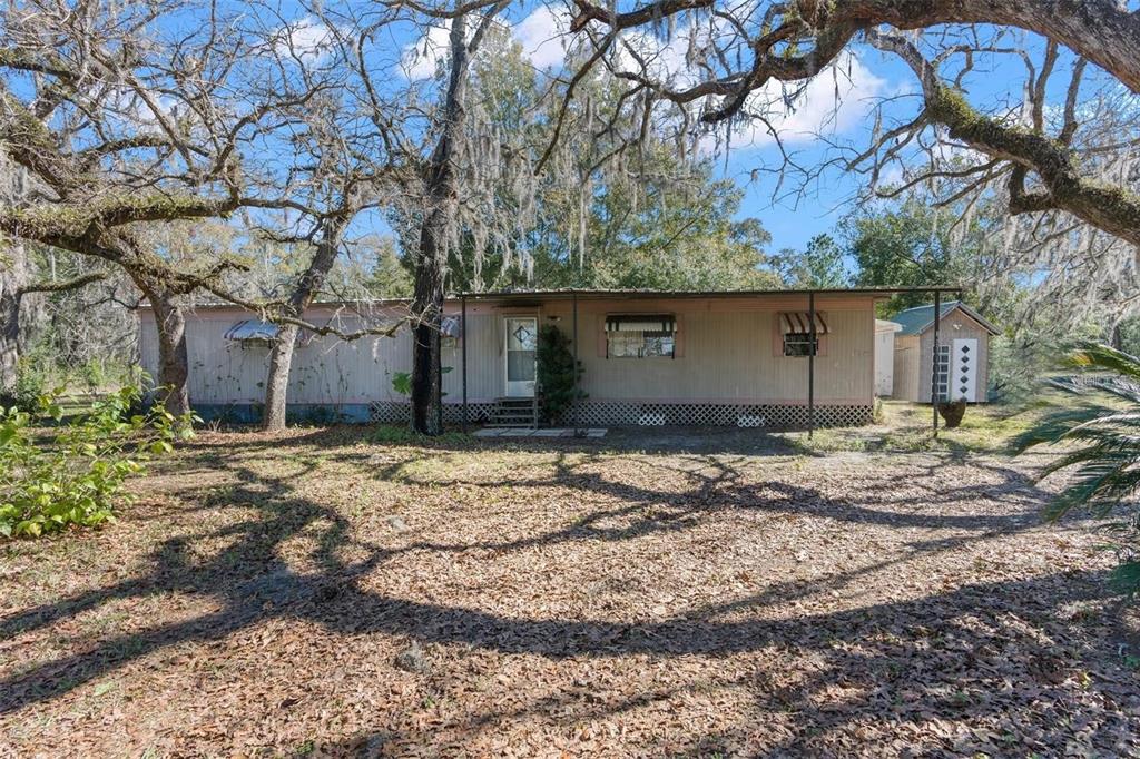 16520 Shady Hills Road Spring Hill, FL 34610 - Photo 1 of 1 a backyard of a house with lots of green space