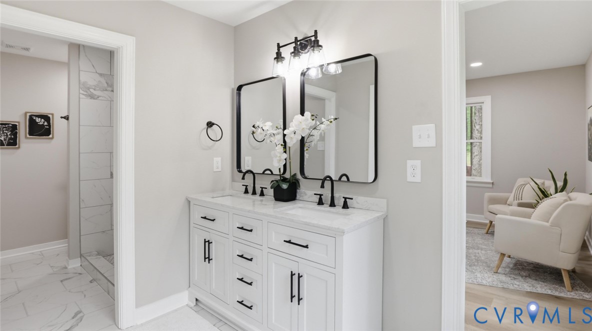 3200 Portugee Road Sandston, VA 23150 - Photo 5 of 26 a en suite bathroom with a double vanity sink a mirror and a shower