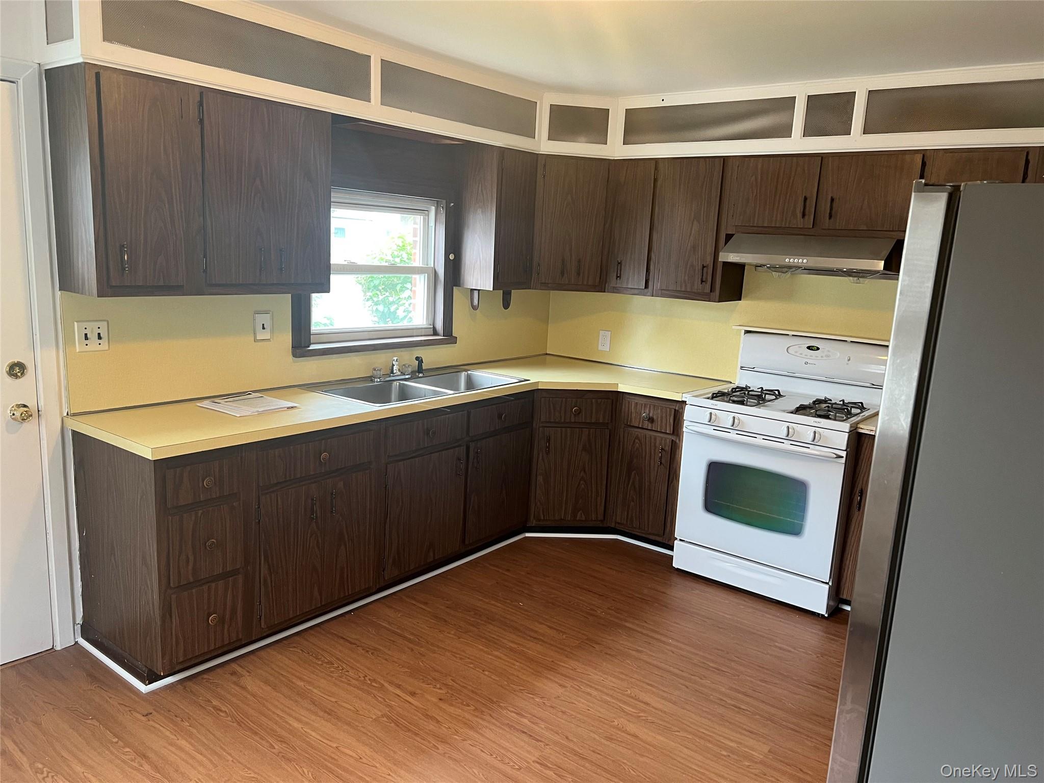 8 Gables Road Hicksville, NY 11801 - Photo 5 of 9 a kitchen with stainless steel appliances a sink a stove a refrigerator and cabinets