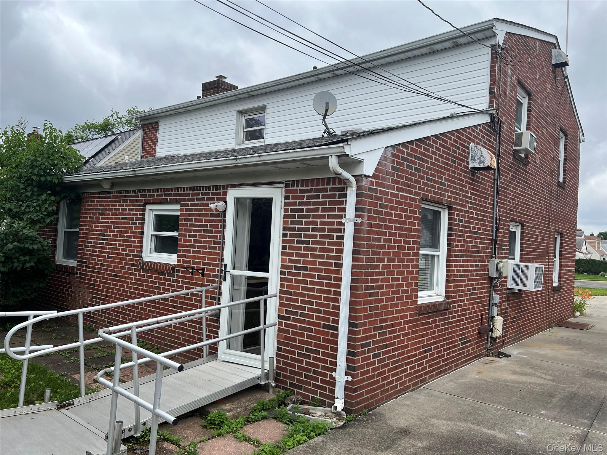 8 Gables Road Hicksville, NY 11801 - Photo 8 of 9 a front view of a house with a garage