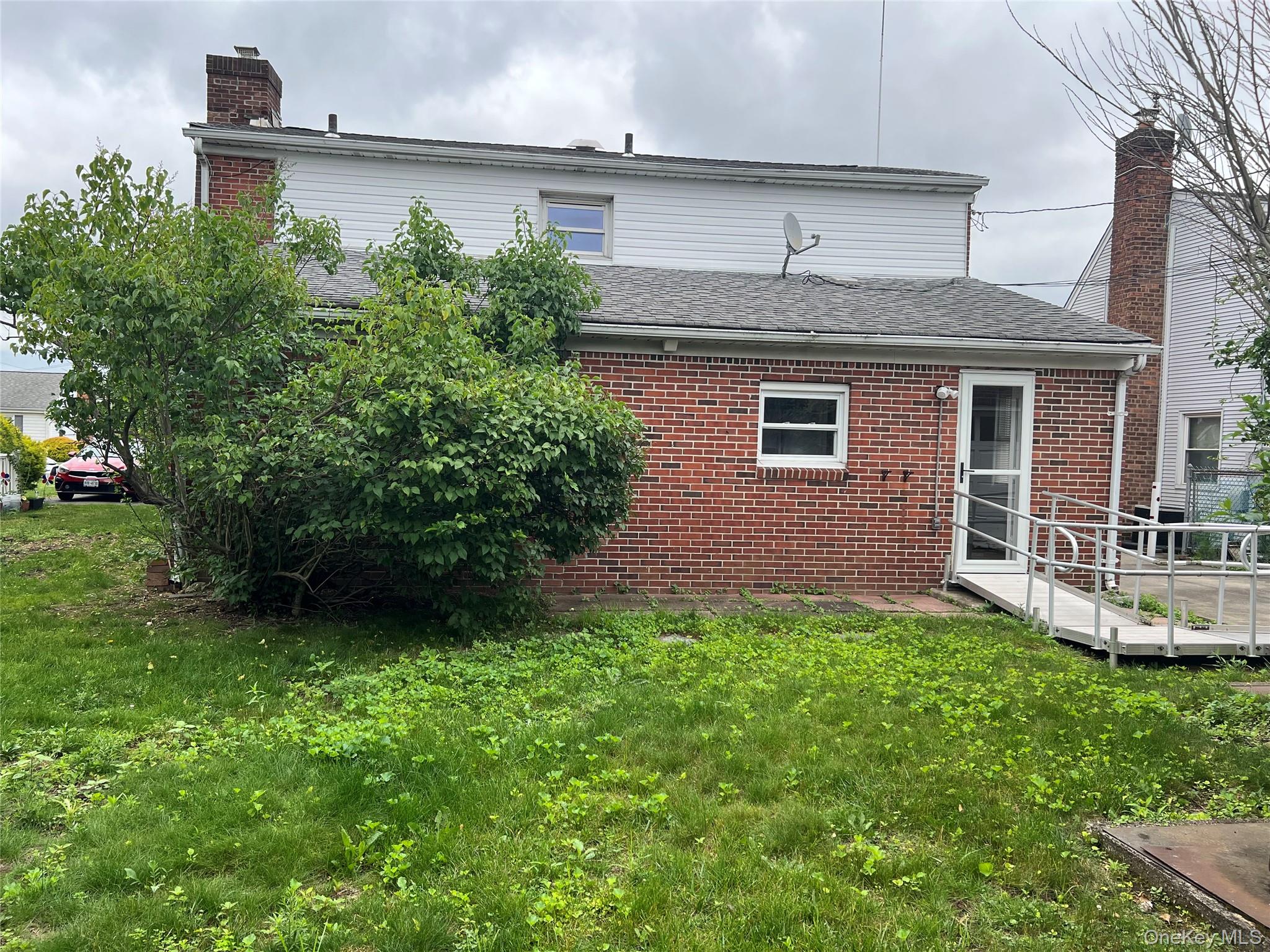 8 Gables Road Hicksville, NY 11801 - Photo 9 of 9 a front view of a house with a yard