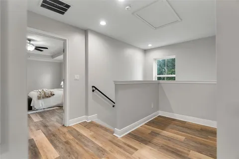a view of a livingroom with wooden floor and a window